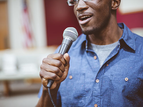 Man holding microphone at hearing