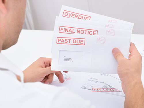 A man holding a pile of bills