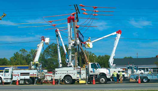 utility company trucks repairing a power line