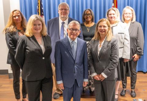 Maureen Willis and Governor Mike DeWine and OCC staff photo during swearing in ceremony